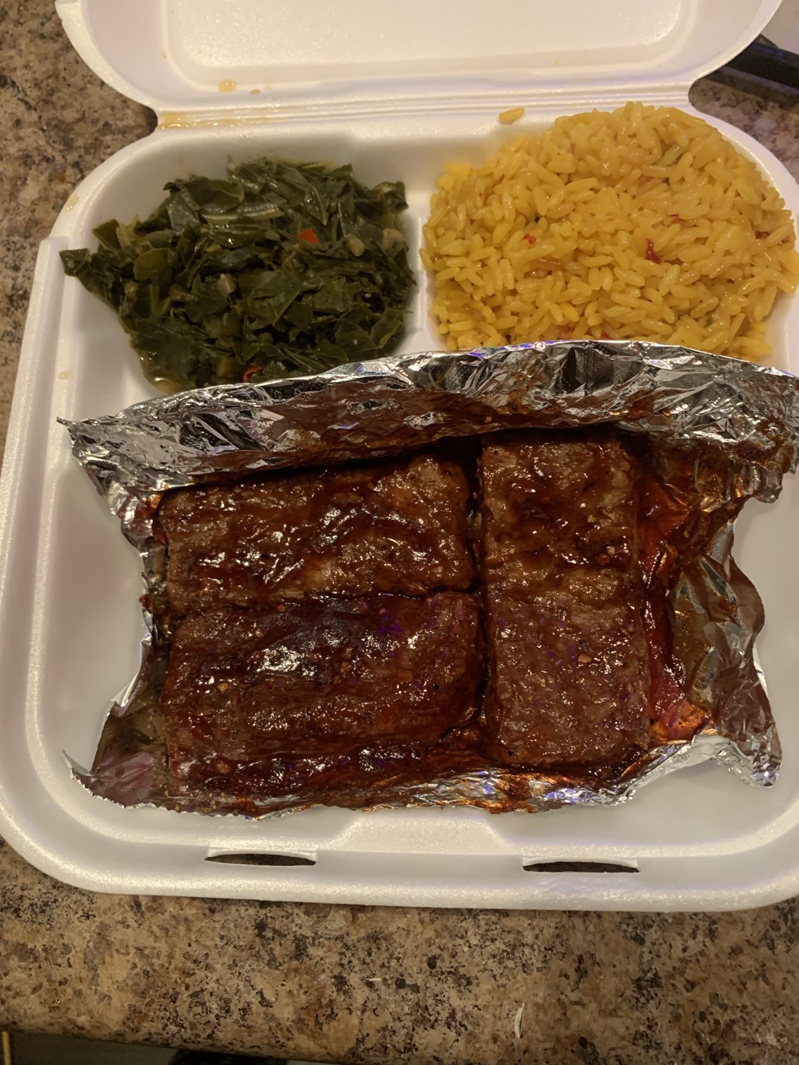 Vegan barbecue ribs dinner with collard greens and yellow rice